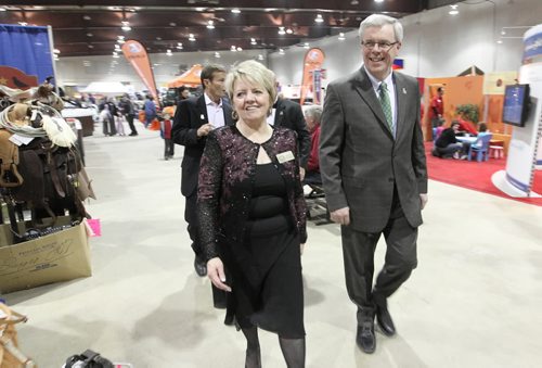 Brandon Sun Provincial Exhibition General Manager Karen Oliver leads Premier Greg Selinger on a quick tour of the Royal Manitoba Winter Fair following Thursday's funding announcement for the Dome Building. (Bruce Bumstead/Brandon Sun)