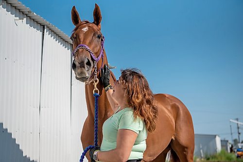 ALEX LUPUL / WINNIPEG FREE PRESS  

Xtrema, a 3-year old filly who recently won the Jack Hardy Stakes, and its groomer Susan Crane pose for a portrait together at Assiniboia Downs in Winnipeg on Thursday, July 8, 2021.

Reporter: George Williams