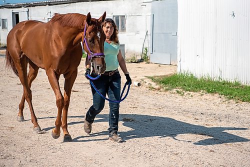 ALEX LUPUL / WINNIPEG FREE PRESS  

Xtrema, a 3-year old filly who recently won the Jack Hardy Stakes, and its groomer Susan Crane pose for a portrait together at Assiniboia Downs in Winnipeg on Thursday, July 8, 2021.

Reporter: George Williams