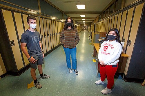 MIKE DEAL / WINNIPEG FREE PRESS
Summer Students (from left) Dan Latimer, 16, Ayesha Raza, 16, and Anne Santos, 17, in a hallway at Grant Park High School Friday afternoon.
The phone lines in the summer school office in Manitoba's largest board were ringing constantly as enrolment got underway for in-person summer classes. Parents and students alike were anxious to confirm the classes are, in fact, being held in person this year. Enrolment has skyrocketed in comparison to previous years. 
See Maggie Macintosh story
210707 - Wednesday, July 07, 2021.