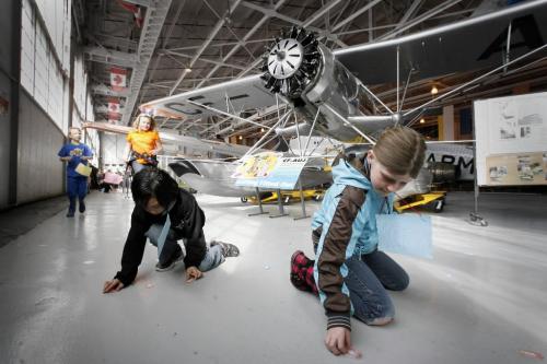 MIKE.DEAL@FREEPRESS.MB.CA 100403 - Saturday, April 3rd, 2010 Adrian Franco (left), 8, and Kiera Davison, 9, scramble to find paper easter eggs during the Western Canada Aviation Museum's Egg Hunt Saturday morning. MIKE DEAL / WINNIPEG FREE PRESS