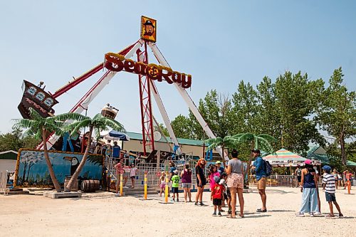 Daniel Crump / Winnipeg Free Press. People wait in line to ride the Sea Ray at Tinkertown on Saturday. The park has seen good attendance despite the heat. July 10, 2021.