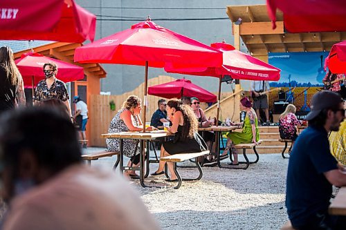 MIKAELA MACKENZIE / WINNIPEG FREE PRESS

Folks hang out on the patio before Bullrider plays at Blue Note Park in Winnipeg on Friday, July 9, 2021. For Melissa Martin story.
Winnipeg Free Press 2021.