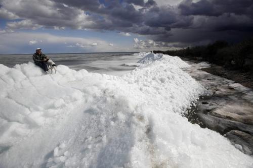 BORIS.MINKEVICH@FREEPRESS.MB.CA  100404 BORIS MINKEVICH / WINNIPEG FREE PRESS A man and his dog explore on top of a massive pile of lake ice at Stephenson Point near Winnipeg Beach. **the guy's name was Gary but said didn't want his name used. He lives in the area.**