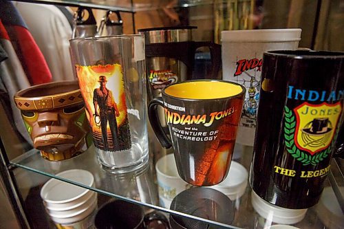 MIKE DEAL / WINNIPEG FREE PRESS
A display case filled with various branded cups and glasses.
Les David owner of the world's largest collection of Raiders of the Lost Ark and Indiana Jones memorabilia. Les is currently conducting an official count of his stuff, for entry into the Guinness Book of World Records.
Les and his wife moved to a farmstead about 15 years ago, expressly to have a place for his collection. It's kept in a self-contained, climate-controlled room built inside his barn.
210708 - Thursday, July 08, 2021.