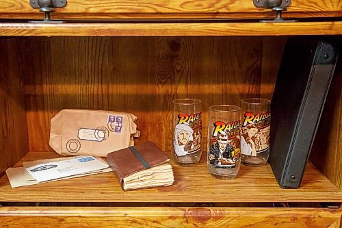 MIKE DEAL / WINNIPEG FREE PRESS
Replica of grail diary and unproduced promotion glasses and a binder holding artist designs for the glasses.
Les David owner of the world's largest collection of Raiders of the Lost Ark and Indiana Jones memorabilia. Les is currently conducting an official count of his stuff, for entry into the Guinness Book of World Records.
Les and his wife moved to a farmstead about 15 years ago, expressly to have a place for his collection. It's kept in a self-contained, climate-controlled room built inside his barn.
210708 - Thursday, July 08, 2021.