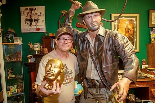 MIKE DEAL / WINNIPEG FREE PRESS
Les David holds a replica of an idol that is a prototype that was to be commercialized but never was, with a life sized mannequin that was created for a chain of DVD stores in Germany in 2003.
Les David owner of the world's largest collection of Raiders of the Lost Ark and Indiana Jones memorabilia. Les is currently conducting an official count of his stuff, for entry into the Guinness Book of World Records.
Les and his wife moved to a farmstead about 15 years ago, expressly to have a place for his collection. It's kept in a self-contained, climate-controlled room built inside his barn.
210708 - Thursday, July 08, 2021.