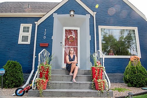 ALEX LUPUL / WINNIPEG FREE PRESS  

Kaitlin Bialek poses for a portrait in front of her Winnipeg home on Thursday, July 15, 2021. Bialek's home has extensive damage from a cement mixture which backed up into her home, due to a city contractor's error in late May.

Reporter: Joyanne Pursaga