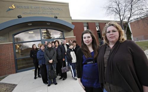 BORIS.MINKEVICH@FREEPRESS.MB.CA  100406 BORIS MINKEVICH / WINNIPEG FREE PRESS Loretta Bell and her 14 year old daughter Casandra stand in front of the River RETSD offices with a group (behind) that are going to bring up a program they do not want to end in the division.