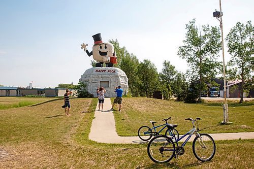 MIKE DEAL / WINNIPEG FREE PRESS
Visitors take a moment to photograph the Happy Rock in the town of Gladstone, MB, where Eileen Clarke the MLA for Agassiz is from.
210716 - Friday, July 16, 2021.