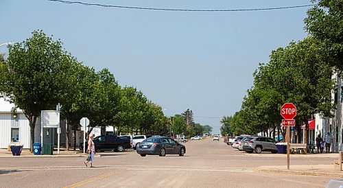 MIKE DEAL / WINNIPEG FREE PRESS
A person crosses Morris Street at the intersection with Dennis Street in the town of Gladstone, MB, where Eileen Clarke the MLA for Agassiz is from.
210716 - Friday, July 16, 2021.