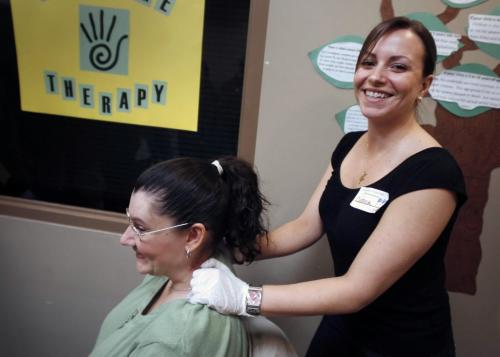MIKE.DEAL@FREEPRESS.MB.CA 100407 - Wednesday, April 7th, 2010 Christina Guerreiro a 2nd year nursing student at UofM as well as a Massage Therapist, gives a much needed neck rub to Heather who stopped by for the open-house health fair at Siloam Mission. See Carol Sanders Story MIKE DEAL / WINNIPEG FREE PRESS