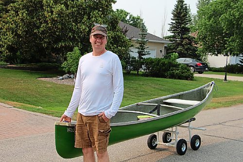 Canstar Community News Shannon Martin walks one of his canoes through La Salle on July 13. Locals can use the canoe for free to paddle down the La Salle River. (GABRIELLE PICHÉ/CANSTAR COMMUNITY NEWS/HEADLINER)