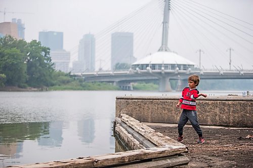 MIKAELA MACKENZIE / WINNIPEG FREE PRESS

Matteo Hebert (eight) throws sticks and mud into the river on the Tache Promenade on a smoky day in Winnipeg on Tuesday, July 20, 2021. Standup.
Winnipeg Free Press 2021.