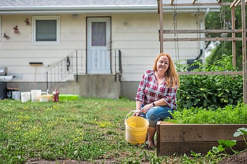 MIKAELA MACKENZIE / WINNIPEG FREE PRESS

Morden resident Theresa Dueck poses for a portrait in her yard on Thursday, July 22, 2021. She has been collecting rain water and the water usually wasted before shower/bath water gets warm to water her vegetable garden. For Kevin Rollason story.
Winnipeg Free Press 2021.