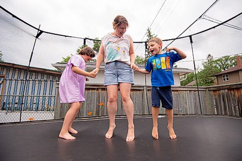 MIKE SUDOMA / Winnipeg Free Press
Sunshine fund recipient Neta Aviv (centre) and her children Ethan Aviv Lakya, 6, (left) and his sister, Alma Aviv, 8,  Lakya (right) share a moment as they jump on their backyard trampoline together Thursday afternoon
July 22, 2021