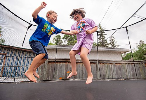 MIKE SUDOMA / Winnipeg Free Press
Sunshine fund recipients, Ethan Aviv Lakya, 6, (left) and his sister, Alma Aviv Lakya, 8, (right) share a moment as they jump on their backyard trampoline together Thursday afternoon
July 22, 2021
