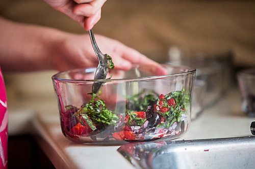 MIKAELA MACKENZIE / WINNIPEG FREE PRESS

Céline Land makes summer bruschetta at home in Winnipeg on Friday, July 23, 2021. For Eva Wasney story.
Winnipeg Free Press 2021.