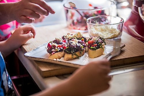 MIKAELA MACKENZIE / WINNIPEG FREE PRESS

Céline Land and her son, Félix (nine), make a summer bruschetta with Vegan Fromagerie feta at home in Winnipeg on Friday, July 23, 2021. For Eva Wasney story.
Winnipeg Free Press 2021.