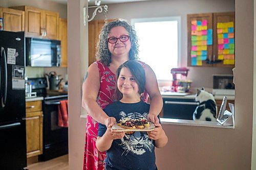 MIKAELA MACKENZIE / WINNIPEG FREE PRESS

Céline Land and her son, Félix (nine), pose for a portrait while holding their summer bruschetta with Vegan Fromagerie feta at home in Winnipeg on Friday, July 23, 2021. For Eva Wasney story.
Winnipeg Free Press 2021.