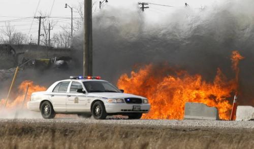 MIKE.DEAL@FREEPRESS.MB.CA 100409 - Friday, April 9th, 2010 A Winnipeg Police Service car approaches a grass fire that got very close to some parked railway cars including a diesel engine along the edges of the CPR North Transcona Railyards between Springfield Road and Bluecher Road. MIKE DEAL / WINNIPEG FREE PRESS