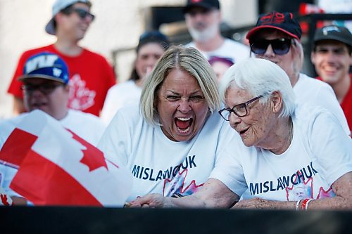 JOHN WOODS / WINNIPEG FREE PRESS
Kim Horrox, family friend, left, and Josephine Leddy, grandmother, right, of Canadian Triathlete Tyler Mislawchuck cheer him on as he races at the Tokyo Olympics at his parents house in Oak Bluff Sunday, July 25, 2021. 

Reporter: Sawatzky