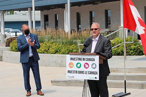 Grant Burr / Winnipeg Free Press
Steinbach Mayor Earl Funk applauds as Steinbach MLA Kelvin Goertzen announces $17.5 million in funding from the provincial and federal governments to support the construction of the $42.5 million Southeast Events Centre in Steinbach on Monday, July 26, 2021.