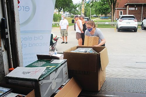 Canstar Community News A community member donates a box of unwanted CDs at a Tuxedo electronic waste drive on July 21.