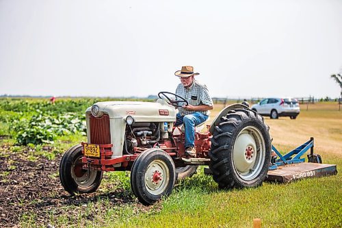 MIKAELA MACKENZIE / WINNIPEG FREE PRESS

Jerry Kroeker mows weeds down before tilling in his 1953 For Golden Jubilee tractor at a new community garden in Steinbach on Tuesday, July 27, 2021. This is the garden's first year operating, and they already have 20 plots going. Standup.
Winnipeg Free Press 2021.