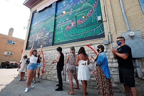 JOHN WOODS / WINNIPEG FREE PRESS
Sophia Stang, co-lead of the Manitoba Advocate for Children and Youths Youth Ambassador Advisory Squad (YAAS!) celebrates after she cuts a ribbon and unveils the first mural created as part of The Re-Right Project Tuesday, July 27, 2021 on the side of Neecheewam's building. 

Reporter: Brown