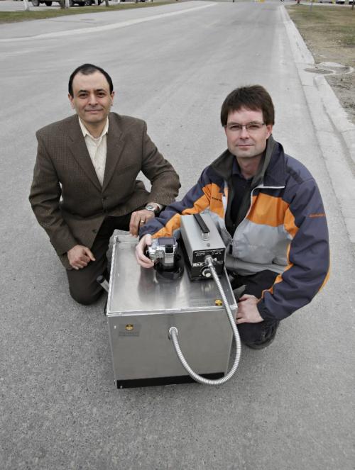 BORIS.MINKEVICH@FREEPRESS.MB.CA  100413 BORIS MINKEVICH / WINNIPEG FREE PRESS Road analyzer story. Dr. Ahmed Shalaby , P.eng and civil engineering research tech Scott Sparrow with the invention that analyzes roads.