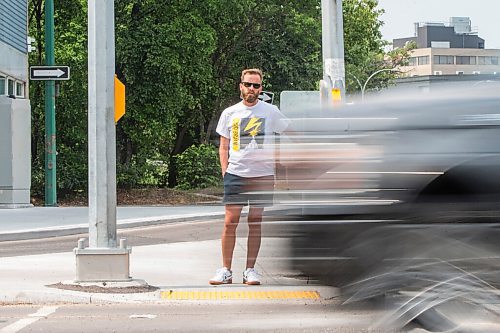 MIKAELA MACKENZIE / WINNIPEG FREE PRESS

Tyler Sneesby poses for a portrait at the intersection of Broadway and Maryland, where the audio sounds for visually impaired folks were mixed up (and telling the person to walk into traffic instead of in the direction of traffic) for months, in Winnipeg on Wednesday, July 28, 2021. For Kevin story.
Winnipeg Free Press 2021.