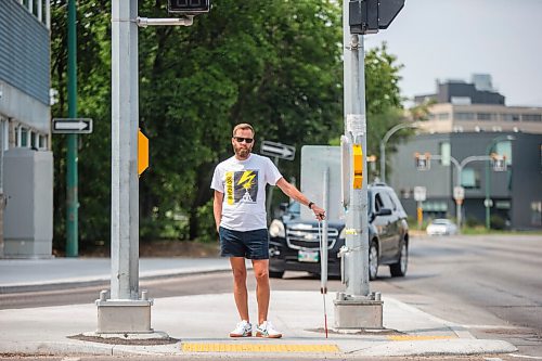 MIKAELA MACKENZIE / WINNIPEG FREE PRESS

Tyler Sneesby poses for a portrait at the intersection of Broadway and Maryland, where the audio sounds for visually impaired folks were mixed up (and telling the person to walk into traffic instead of in the direction of traffic) for months, in Winnipeg on Wednesday, July 28, 2021. For Kevin story.
Winnipeg Free Press 2021.