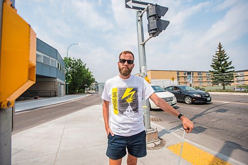 MIKAELA MACKENZIE / WINNIPEG FREE PRESS

Tyler Sneesby poses for a portrait at the intersection of Broadway and Maryland, where the audio sounds for visually impaired folks were mixed up (and telling the person to walk into traffic instead of in the direction of traffic) for months, in Winnipeg on Wednesday, July 28, 2021. For Kevin story.
Winnipeg Free Press 2021.