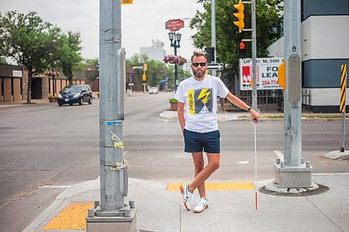 MIKAELA MACKENZIE / WINNIPEG FREE PRESS

Tyler Sneesby poses for a portrait at the intersection of Broadway and Maryland, where the audio sounds for visually impaired folks were mixed up (and telling the person to walk into traffic instead of in the direction of traffic) for months, in Winnipeg on Wednesday, July 28, 2021. For Kevin story.
Winnipeg Free Press 2021.