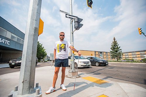 MIKAELA MACKENZIE / WINNIPEG FREE PRESS

Tyler Sneesby poses for a portrait at the intersection of Broadway and Maryland, where the audio sounds for visually impaired folks were mixed up (and telling the person to walk into traffic instead of in the direction of traffic) for months, in Winnipeg on Wednesday, July 28, 2021. For Kevin story.
Winnipeg Free Press 2021.