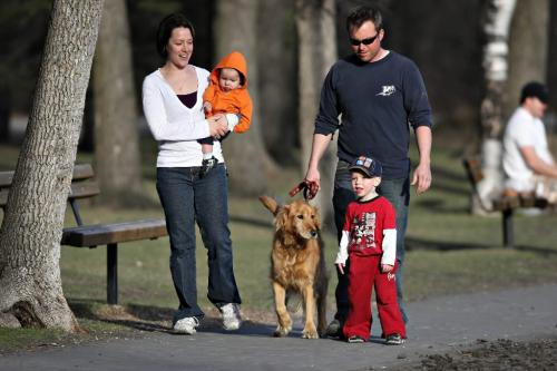 BORIS.MINKEVICH@FREEPRESS.MB.CA  100414 BORIS MINKEVICH / WINNIPEG FREE PRESS St. Vital Park. Michelle and Travis Hodnett with their kids and dog take a stroll around the park's duck pond. The kids names are in orange Brendyn, 8 months, and in red Devon,3, and the dog is Ginger.