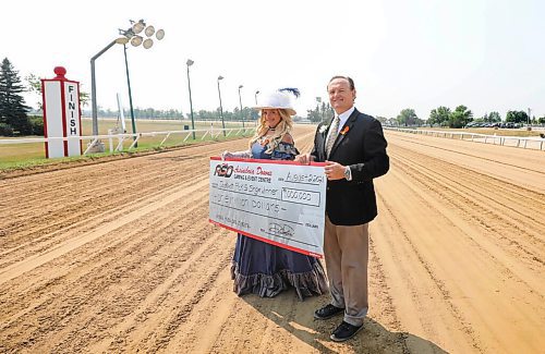 RUTH BONNEVILLE / WINNIPEG FREE PRESS

sports - Assiniboia Downs CEO Darren Dunn

Photo of  Assiniboia Downs CEO Darren Dunn, with Francine Fournier, Angle and Million Dollar Wagering Promotion and Manitoba Derby with mock cheque.  

Place: Assiniboia Downs, taken on track near  in winner's circle.

Reporter  George Williams 


July 29, 2021
