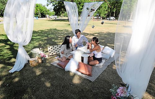 RUTH BONNEVILLE / WINNIPEG FREE PRESS

Local -  Biz or standup

Business partners, Christine Nguyen (left) and An Doan (right) discuss their formal launch to their upscale picnic business called Canopy_Picnic, with Christine's boyfriend, Zandir Narrandes under their canopy at Assiniboine Park Wednesday.  

After taking promo photos of their setup display (formal tableware, cushions, flowers, games and canopy), they decided to sit down at their picnic table and have a business meeting when noticed by FP photog.  

Please contact An Doan for more info.  Info in email to photo desk.


July 28, 2021
