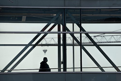 ALEX LUPUL / WINNIPEG FREE PRESS  

A person is seen in silhouette while walking across an above-ground walkway in downtown Winnipeg on Thursday, July, 29, 2021.