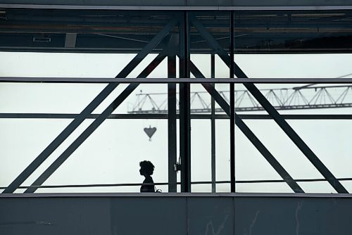 ALEX LUPUL / WINNIPEG FREE PRESS  

A person is seen in silhouette while walking across an above-ground walkway in downtown Winnipeg on Thursday, July, 29, 2021.