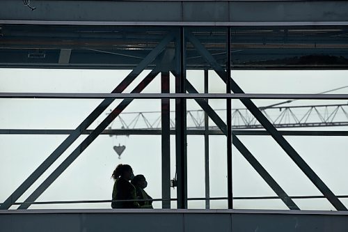 ALEX LUPUL / WINNIPEG FREE PRESS  

A person is seen in silhouette while walking across an above-ground walkway in downtown Winnipeg on Thursday, July, 29, 2021.