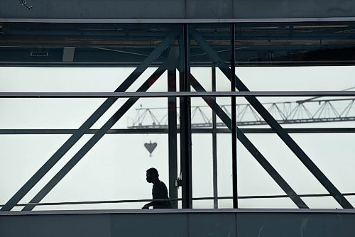 ALEX LUPUL / WINNIPEG FREE PRESS  

A person is seen in silhouette while walking across an above-ground walkway in downtown Winnipeg on Thursday, July, 29, 2021.