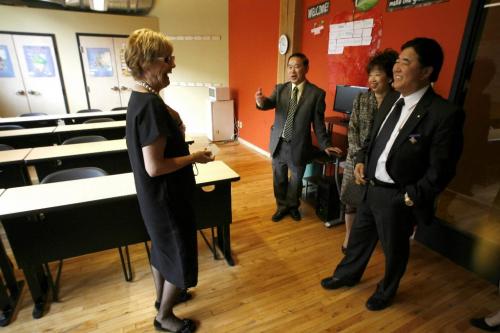 MIKE.DEAL@FREEPRESS.MB.CA 100415 - Thursday, April 15th, 2010 Linda Lalande (left) executive director of Immigrant Centre gives a tour to the Lieutenant Governor of Manitoba, The Honourable Philip Lee (right) and his wife Anita (second from right) during the centre's grand opening. MIKE DEAL / WINNIPEG FREE PRESS