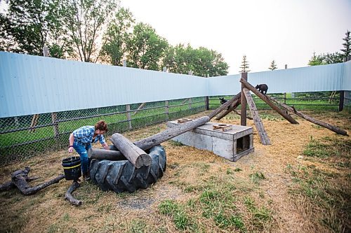 MIKAELA MACKENZIE / WINNIPEG FREE PRESS

Judy Stearns cleans an enclosure at Black Bear Rescue Manitoba near Stonewall on Wednesday, July 7, 2021. For Eva Wasney story.
Winnipeg Free Press 2021.