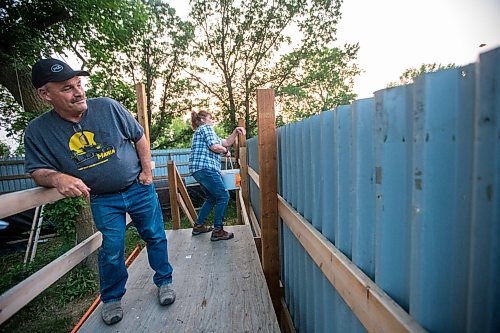 MIKAELA MACKENZIE / WINNIPEG FREE PRESS

Judy and Roger Stearns throw expired produce into the enclosure while remaining hidden from the cubs at Black Bear Rescue Manitoba near Stonewall on Wednesday, July 7, 2021. For Eva Wasney story.
Winnipeg Free Press 2021.