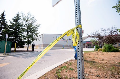 MIKE SUDOMA / Winnipeg Free Press
Police tape hangs from a sign at a scene of an assault in the parking lot of the Jonathan Toews Community Centre Friday afternoon
July 30, 2021