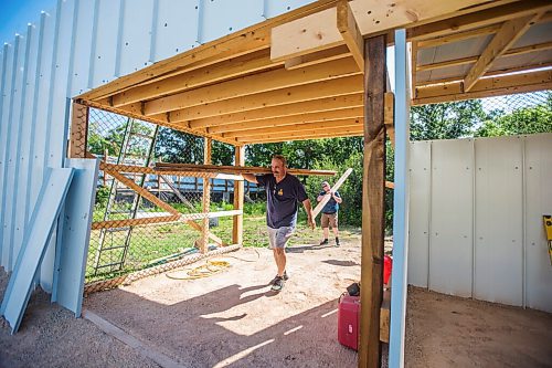 MIKAELA MACKENZIE / WINNIPEG FREE PRESS

Roger Stearns carries deck-building materials into on the newest enclosure at Black Bear Rescue Manitoba near Stonewall on Sunday, July 25, 2021. For Eva story.
Winnipeg Free Press 2021.