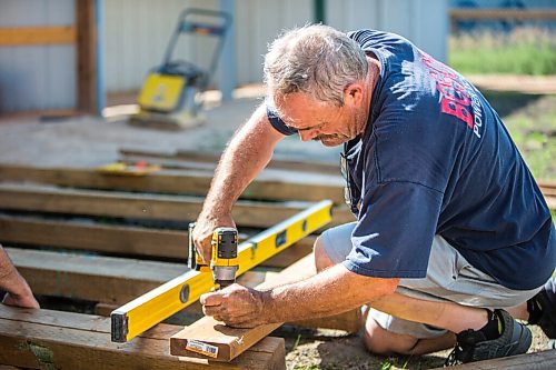 MIKAELA MACKENZIE / WINNIPEG FREE PRESS

Roger Stearns builds a deck for the pool in the newest enclosure at Black Bear Rescue Manitoba near Stonewall on Sunday, July 25, 2021. For Eva story.
Winnipeg Free Press 2021.