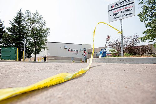 MIKE SUDOMA / Winnipeg Free Press
Police tape hangs from a sign at a scene of an assault in the parking lot of the Jonathan Toews Community Centre Friday afternoon
July 30, 2021